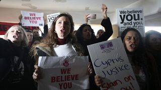 Protesters shout slogans outside a court before the arrival of a 19 year-old British woman that was found guilty of making up claims she was raped by up to 12 Israelis.