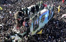 Coffins of Gen. Qassem Soleimani and others who were killed in Iraq by a U.S. drone strike, are carried on a truck during a funeral procession, in the city of Kerman, Iran