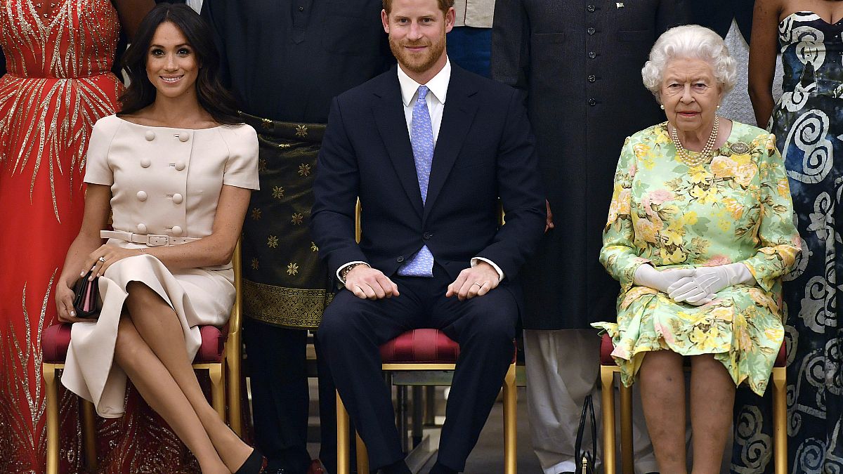 Queen Elizabeth II with the Duke and Duchess of Sussex at the Queen's Young Leaders Awards Ceremony at Buckingham Palace, London, Tuesday June 26, 2018. 