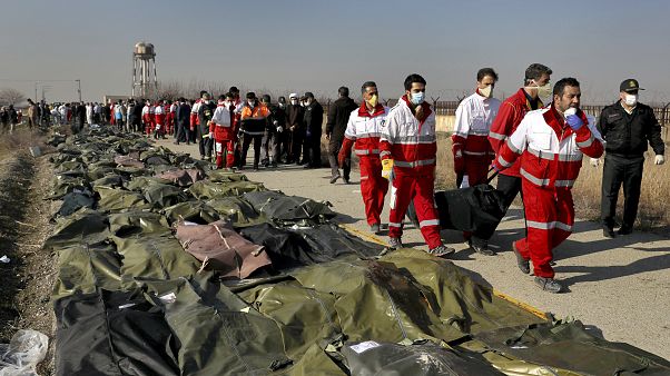 Rescue workers carry the body of a victim of an Ukrainian plane crash in Shahedshahr, southwest of the capital Tehran, Iran, Wednesday, Jan. 8, 2020. Rescue workers carry the body of a victim of an Ukrainian plane crash in Shahedshahr, southwest of the capital Tehran, Iran, Wednesday, Jan. 8, 2020.
