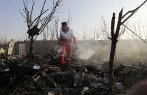 A rescue worker searches the scene where an Ukrainian plane crashed in Shahedshahr, southwest of the capital Tehran, Iran, Wednesday, Jan. 8, 2020.