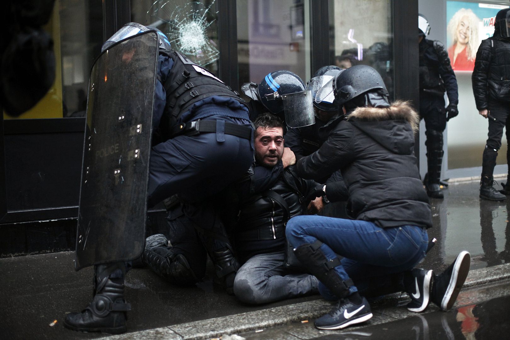 A protestor is arrested by riot police officers during a demonstration on Thursday, 9 January 2020.
