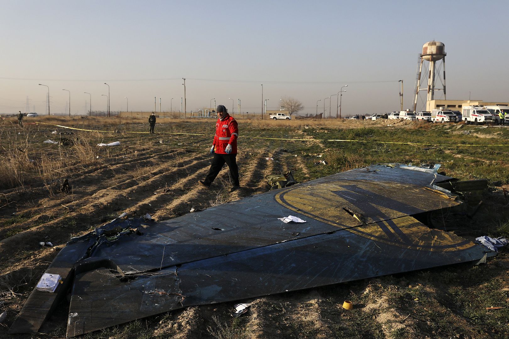 A rescue worker searches the scene where the Ukrainian plane crashed near the capital Tehran, Iran.