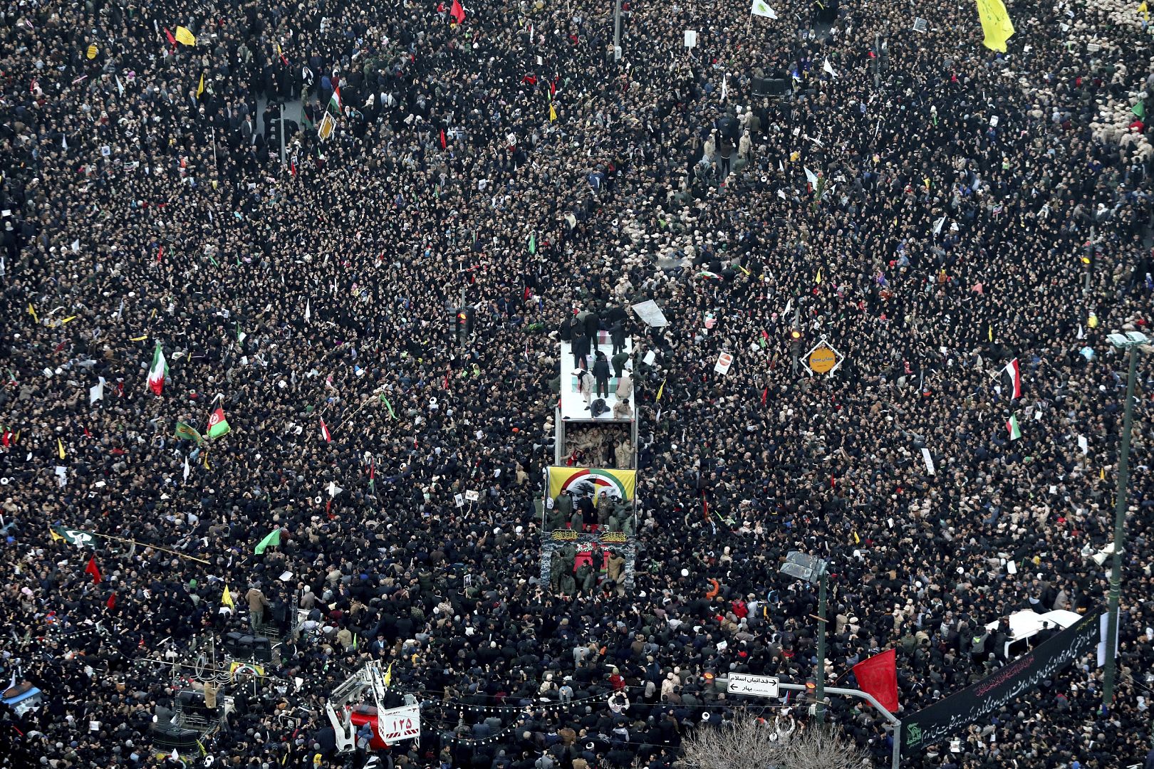 The coffins of Gen. Qassem Soleimani and others who were killed in Iraq by a U.S. drone strike, are carried on a truck surrounded by mourners during a funeral procession.