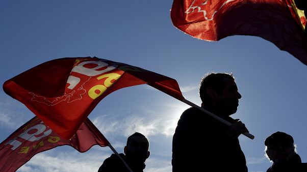 Protesters hold flags during a demonstration in Lyon, central France, Thursday, Jan. 9, 2020. Protesters hold flags during a demonstration in Lyon, central France, Thursday, Jan. 9, 2020.
