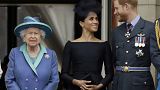 Britain's Queen Elizabeth II, and Meghan the Duchess of Sussex and Prince Harry watch a flypast of Royal Air Force aircraft pass over Buckingham Palace in London