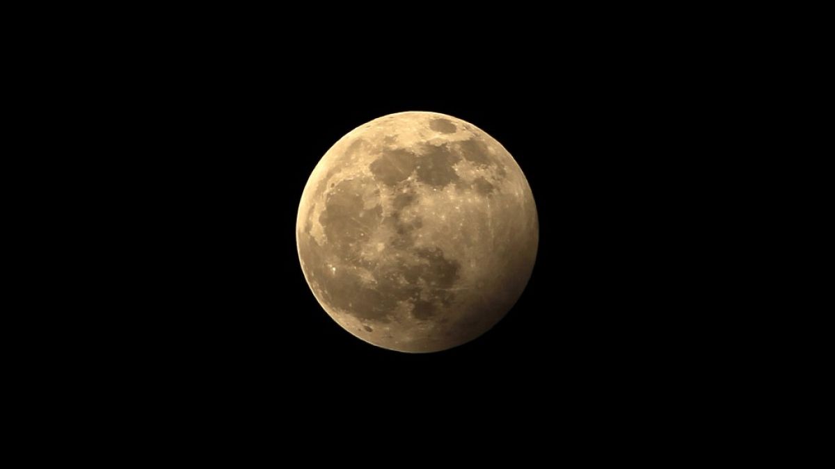 The full moon during the penumbral lunar eclipse is seen on the outskirts of Chandigarh