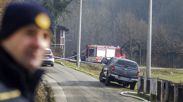 A police officer stands near the burnt nursing home in Andrasevac, northern Croatia. A police officer stands near the burnt nursing home in Andrasevac, northern Croatia.