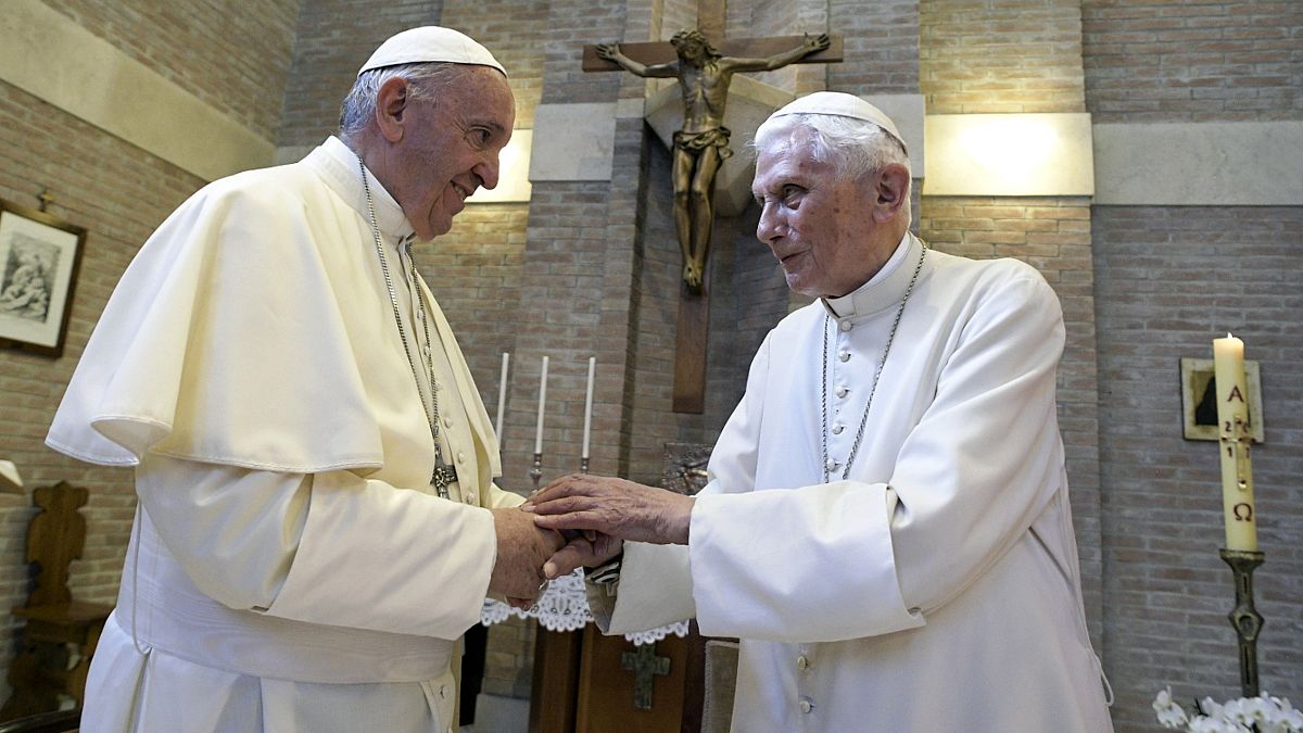 Pope Francis, left, and Pope Emeritus Benedict XVI, meet each other on the occasion of the elevation of five new cardinals