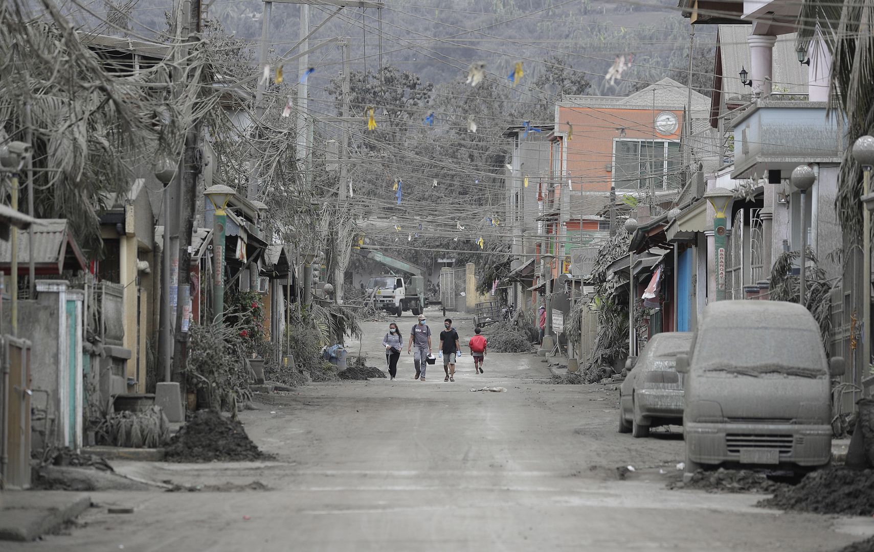 Animal volunteers search for pets left by owners as they fled to evacuation centers after Taal volcano eruption in Lemery, Batangas, southern Philippines. 15 January 2020