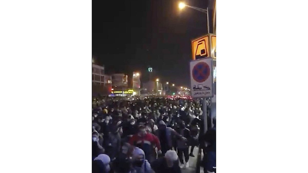 This frame grab from a Sunday, Jan. 12, 2020 video provided by the New York-based Center for Human Rights in Iran shows a crowd fleeing police in Tehran, Iran. 