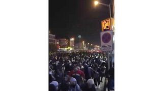 This frame grab from a Sunday, Jan. 12, 2020 video provided by the New York-based Center for Human Rights in Iran shows a crowd fleeing police in Tehran, Iran. 