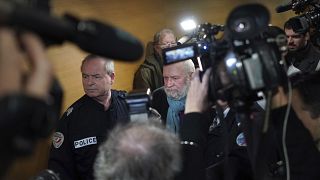 Former French priest Bernard Preynat, center, arrives at the Lyon court house, central France, Monday Jan.13, 2020.