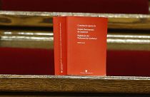 A book of the Spanish constitution is placed on the benches of opposition Catalan lawmakers inside the Catalan parliament in Barcelona, Spain, Friday, Oct. 27, 2017