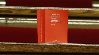A book of the Spanish constitution is placed on the benches of opposition Catalan lawmakers inside the Catalan parliament in Barcelona, Spain, Friday, Oct. 27, 2017