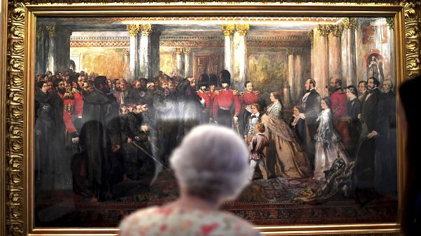 Queen Elizabeth II looks at a painting of Queen Victoria Queen Elizabeth II looks at a painting of Queen Victoria