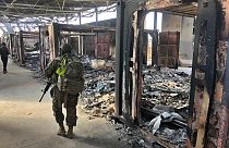 U.S. Soldiers walk past a site of Iranian bombing at Ain al-Asad air base, in Anbar, Iraq, Monday, Jan. 13, 2020.