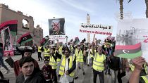 In this April 19, 2019 file photo, protesters wear yellow vests at a protest as they wave national flags and chant slogans against Libya's Field Marshal Khalifa Hafter
