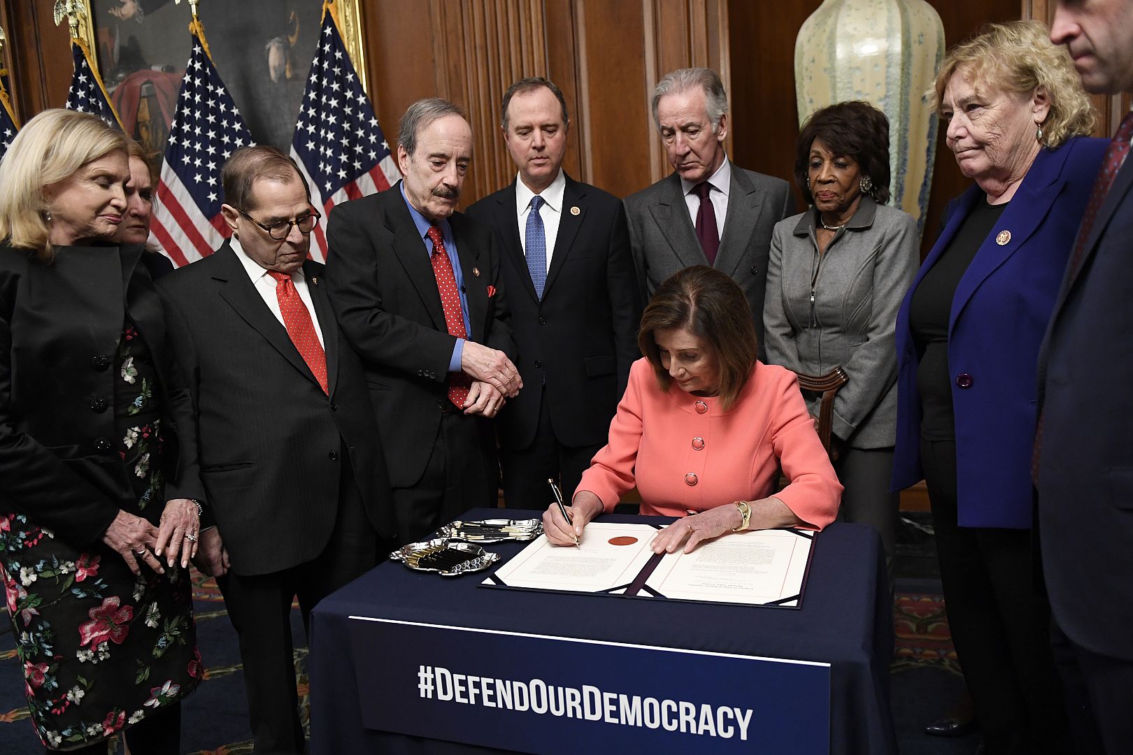 House Speaker Nancy Pelosi of Calif., signs the resolution to transmit the two articles of impeachment against President Donald Trump to the Senate for trial on Capitol Hill.