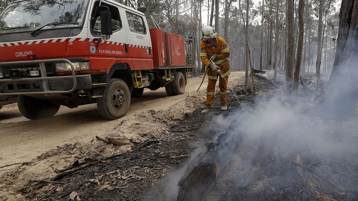 A firefighter patrols a controlled fireat a wildfire near Bodalla, Australia