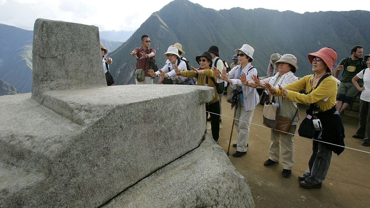 People tour the ruins of Machu Picchu near Cuzco, Peru  March 26, 2008 file photo