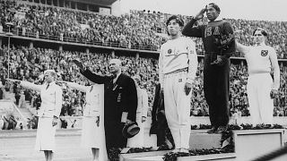 Jesse Owens receives one of four gold medals at the 1936 Olympic Games in Berlin.