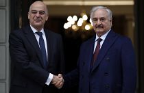 Libyan Gen. Khalifa Hafter, right, and Greek Foreign Minister Nikos Dendias shake hands before their meeting in Athens, Friday, Jan. 17, 2020