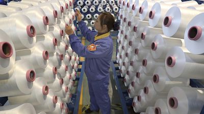 An employee works in a chemical fiber plant in Nantong in eastern China’s Jiangsu Province 