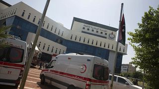 سيارات إسعاف أمام مقر شركة النفط الوطنية بعد هجوم شنه مسلحون في طرابلس