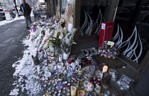 Snow-covered flowers and candles are seen outside of the family bakery of Ayeshe Pourghadheri and her daughter Fatemah Pasavand in North Vancouver, B.C.