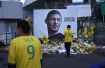 Nantes team supporters in front of a poster of Emiliano Sala that says "Let's keep hope"
