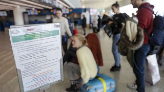 A notice explaining precautions to be taken by people traveling to Wuhan, China, is seen at a terminal of Rome's International Fiumicino airport, Tuesday, Jan. 21, 2020.