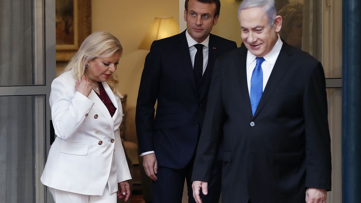 French President Emmanuel Macron, center, looks on as he stands next to Israeli Prime Minister Benjamin Netanyahu and his wife Sara, Jerusalem, Wednesday  Jan. 22, 2020