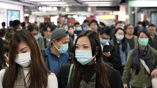 FILE PHOTO: Passengers wear masks to prevent an outbreak of a new coronavirus in a subway station, in Hong Kong, Wednesday, Jan. 22, 2020. 