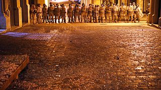 Lebanese army soldiers deploy on a street where anti-government protesters clash with riot police, during a protest against the new government, in downtown Beirut, Lebanon, We