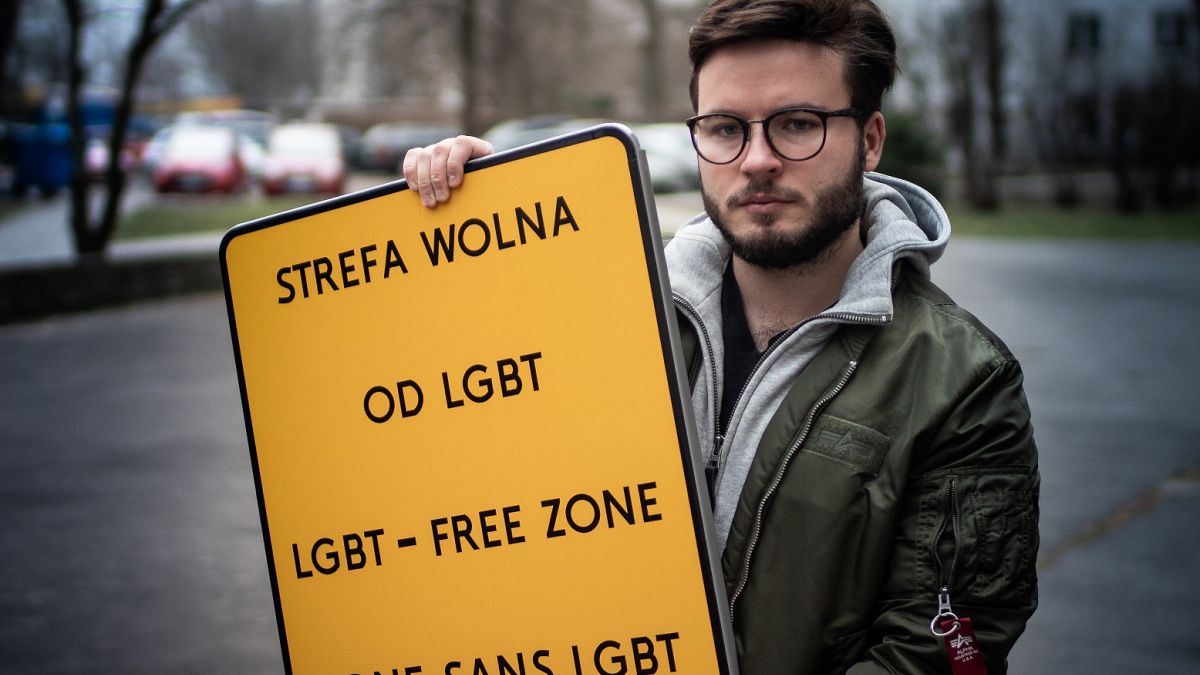 Bart Staszewski with a "LGBT-FREE ZONE" sign he created for his campaign.