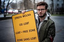 Bart Staszewski with a "LGBT-FREE ZONE" sign he created for his campaign.