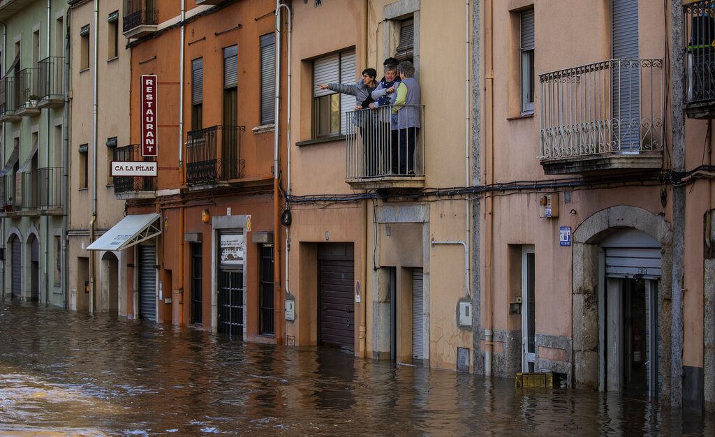 People stand at a balcony during floodings following a storm in Girona, Spain. 23 January 2020.