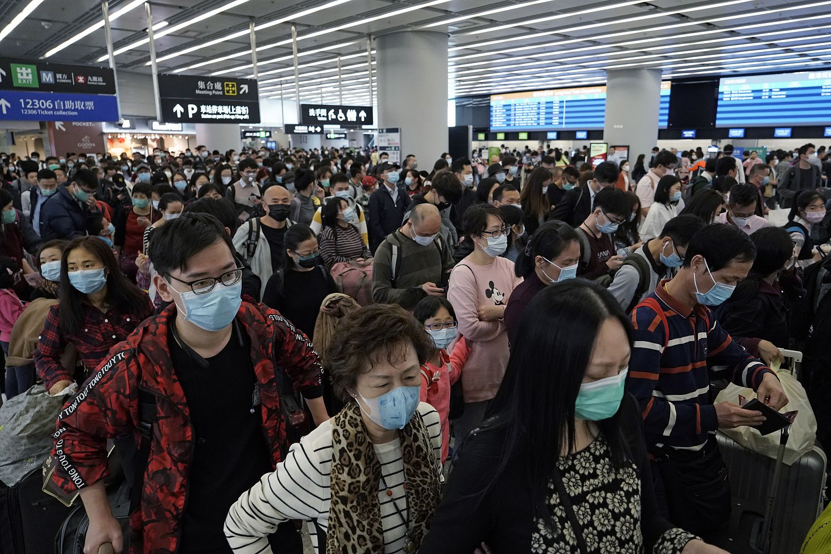 Passengers wear protective face masks at the departure hall of the high-speed train station in Hong Kong. 23 January 2020.