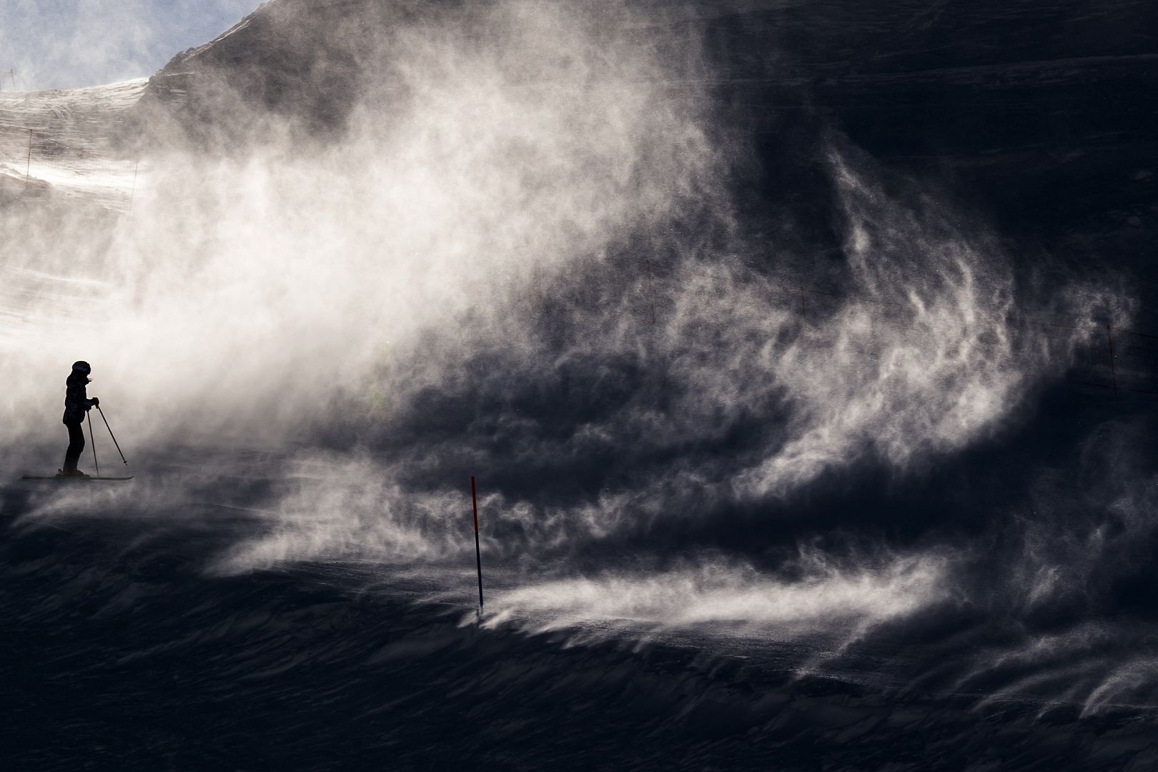 Skiers make their way in strong winds, in Leysin, Switzerland.