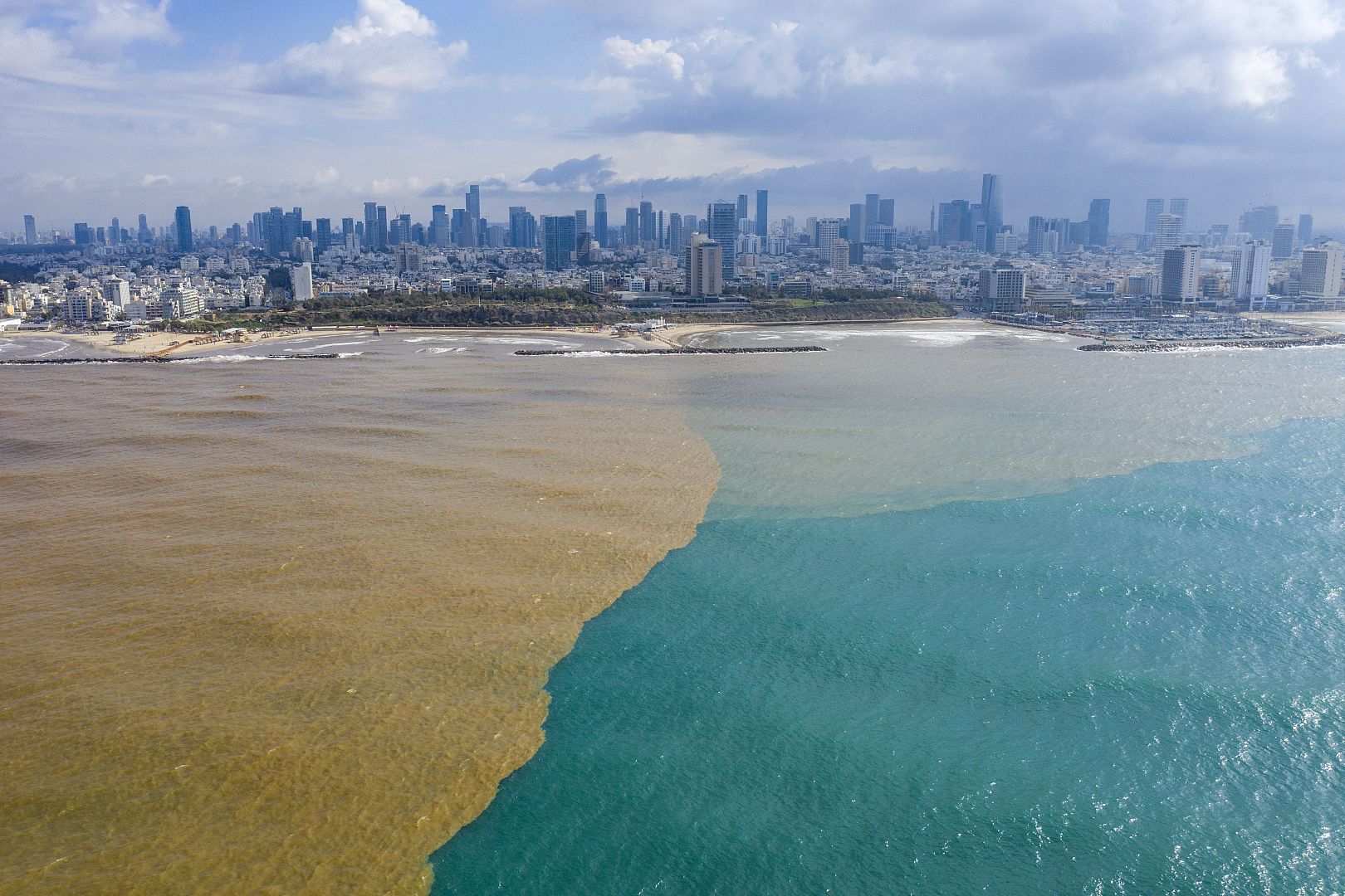 Mud water from Hayarkon river flows in to the Mediterranean Sea in Tel Aviv, Israel.