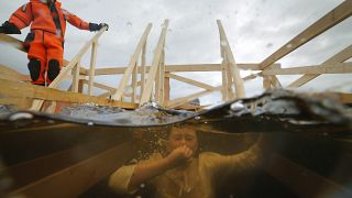 A Russian Orthodox believer swimming in the icy water in the Neva River during a traditional Epiphany celebration in St.Petersburg, Russia.