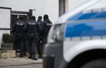 Police stand in front of an apartment building in Erfurt as they carried out raids on the day Germany banned the neo-Nazi group 'Combat 18' Deutschland, Jan. 23, 2020.