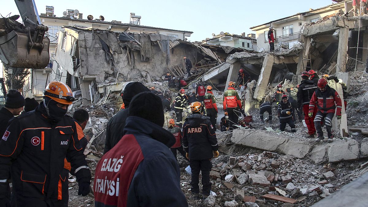 Rescue workers work to save people trapped under debris in Elazig, eastern Turkey, Sunday, Jan. 26, 2020.