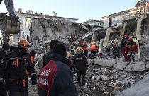 Rescue workers work to save people trapped under debris in Elazig, eastern Turkey, Sunday, Jan. 26, 2020.
