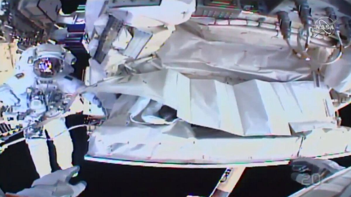 This photo provided by NASA shows the view from NASA's Andrew Morgan's helmet cam as Italian astronaut Luca Parmitano works outside the International Space Station