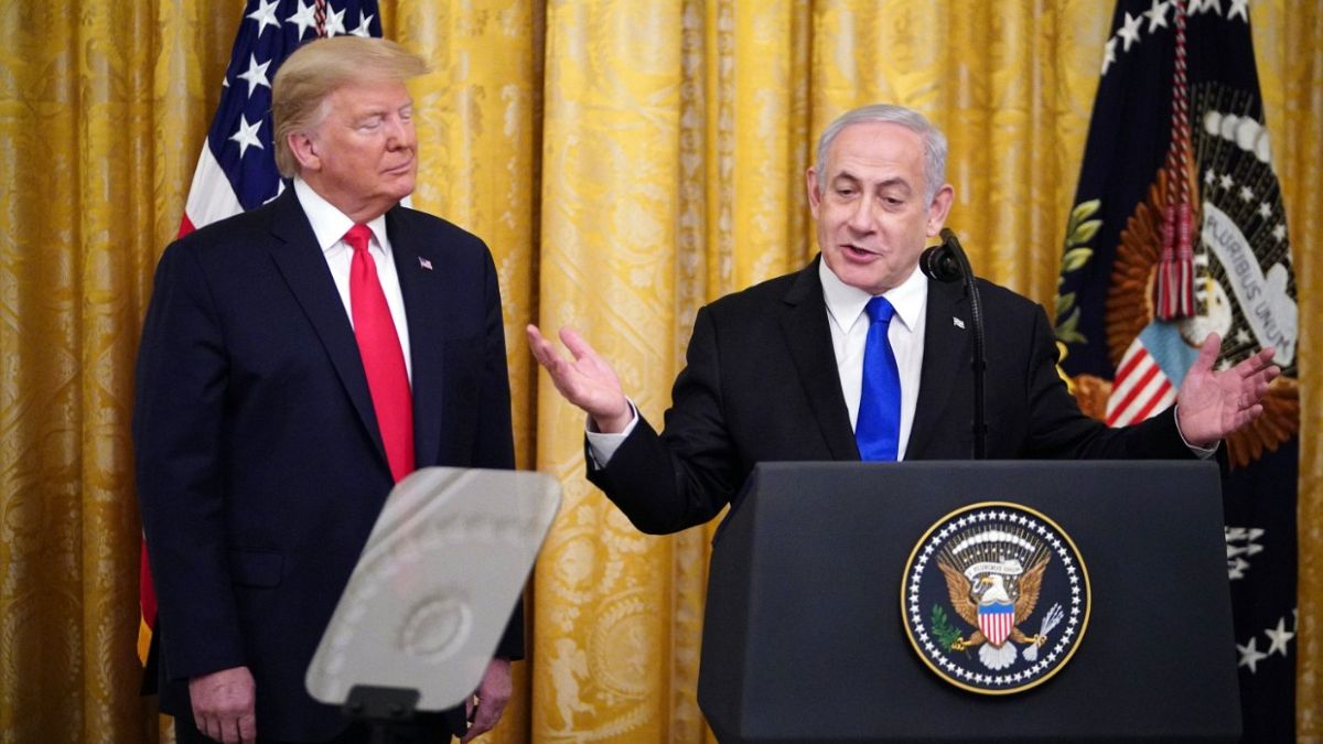 Israeli Prime Minister Benjamin Netanyahu, with US President Donald Trump, speaks during an announcement of Trump's Middle East peace plan in White House on January 28, 2020