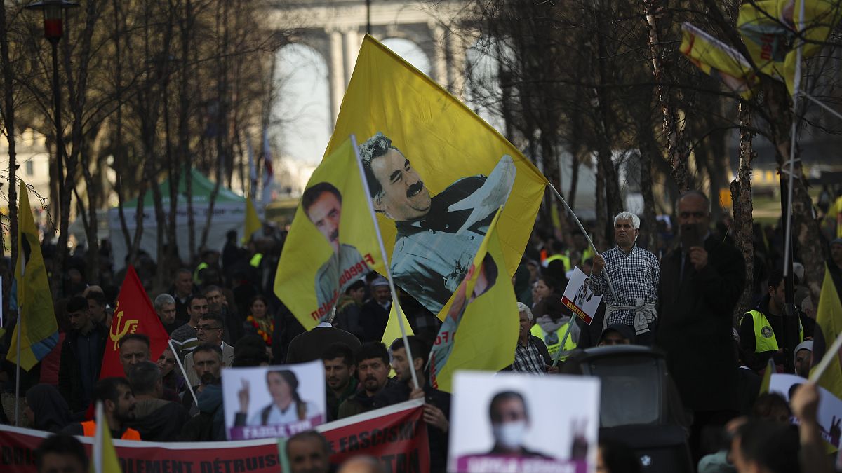 Pro-Kurdish people wave flags with the face of jailed PKK leader, Abdullah Ocalan, during a protest demanding his freedom in Brussels in February 2019.