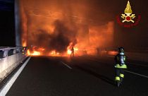 In this photo released by the Italian Firefighters, firemen try to extinguish a dozen vehicles on fire on a highway near Milan, Italy, in the early hours on Jan. 29.