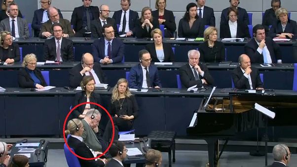 German right-wing MP closes eyes and slumps during Holocaust speech German right-wing MP closes eyes and slumps during Holocaust speech
